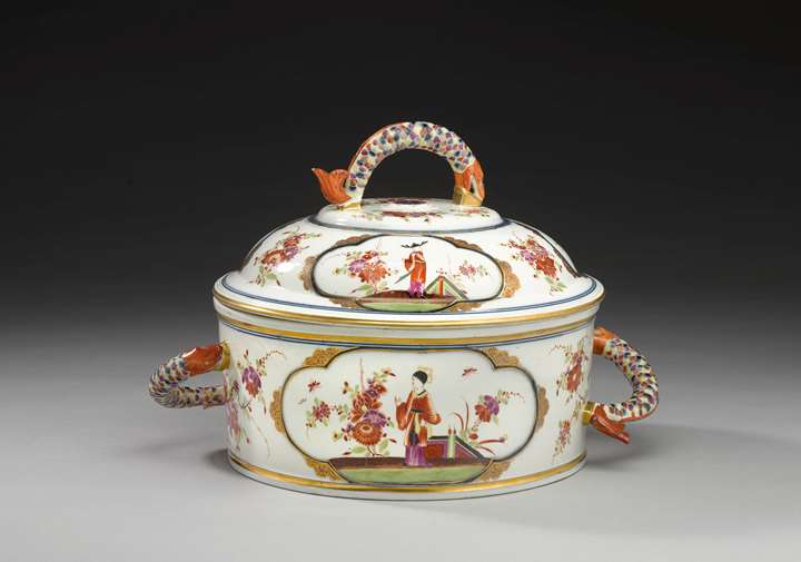 A large covered tureen with fish handles decorated with polychrome chinoiserie scenes